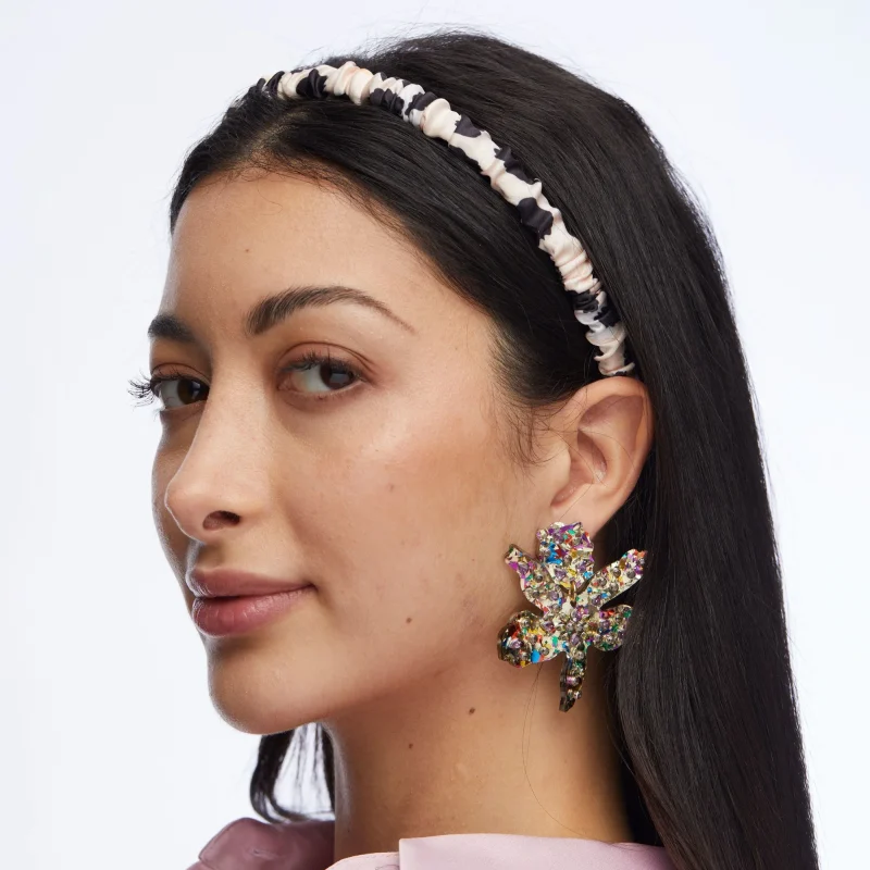 Model wearing House of 29 x Lele Sadoughi Rainbow Confetti Small Paper Lily Earrings – vibrant multicolor confetti floral earrings styled as a statement accessory, lightweight yet eye-catching design that adds playful color to any outfit, chic fashion jewelry trend 2025 for summer parties, weddings, or everyday glam.